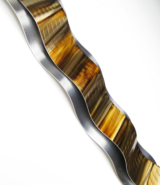 Metal wall sculpture, gold color, angled view