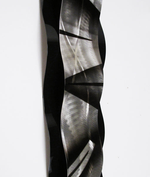 detail view of metal wall sculpture on white background