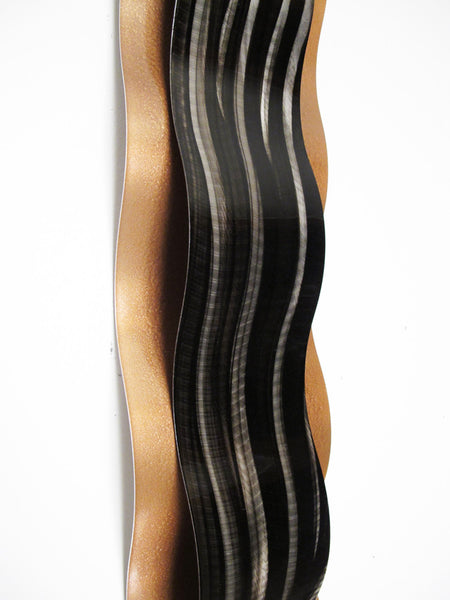 Copper colored wall art sculpture on white background