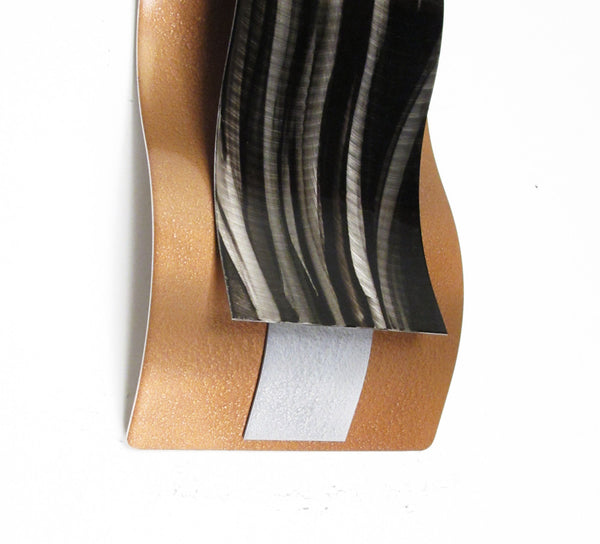 copper colored wall sculpture detail view