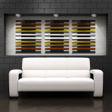 Abstract wall sculpture mounted above white sofa